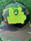 Embroidered iron-on patch reading LOL What in bold lettering. The patch showcases clean stitching and vibrant green and yellow colors, perfect for customizing clothing or trucker hats.