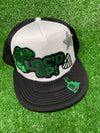 White & Black trucker hat with the text 'Loc’d Up' embroidered in bold black and green letters with other accent patches. The hat features a classic mesh back and adjustable snap closure, perfect for showcasing your locs with style.