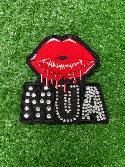 Custom MUA patch with old red lipstick graphic and gems.