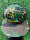 Embroidered iron-on patch reading Money Spender in bold stylish lettering. The patch showcases clean stitching and vibrant green and yellow colors, perfect for customizing clothing or trucker hats.