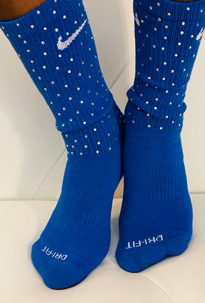 Blue Nike socks embellished with sparkling rhinestones, adding a touch of bling and style.  The socks feature a bold blue color with rhinestones carefully placed for a dazzling effect, perfect for elevating any sneaker look.