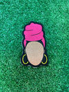 Embroidered patch featuring a faceless Nubian queen with a vibrant pink headwrap and yellow hoop earrings on a black background.