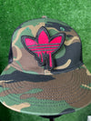 Detailed view of a pink Adidas iron-on patch with the classic trefoil logo and three stripes, perfect for adding a stylish, personalized touch to clothing.