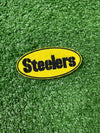 Embroidered Pittsburgh Steelers iron-on patch with the words Steelers in bold black letters on a yellow background. The stitching is clean and precise, ideal for adding a touch of team spirit to your clothing or accessories.