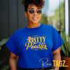 A vibrant blue shirt featuring a stylish 'Pretty Poodle' graphic. The text is elegantly displayed in shimmering gold/yellow font, creating a stunning contrast against the blue background.