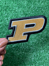 Purdue University iron on patch featuring the iconic P logo in bold black, gold, and white. colors. Ready to be applied to jackets, bags, or trucker hats.