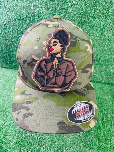 An embroidered patch featuring a black woman with a high puff hairstyle, bold red lips and a serene expression.