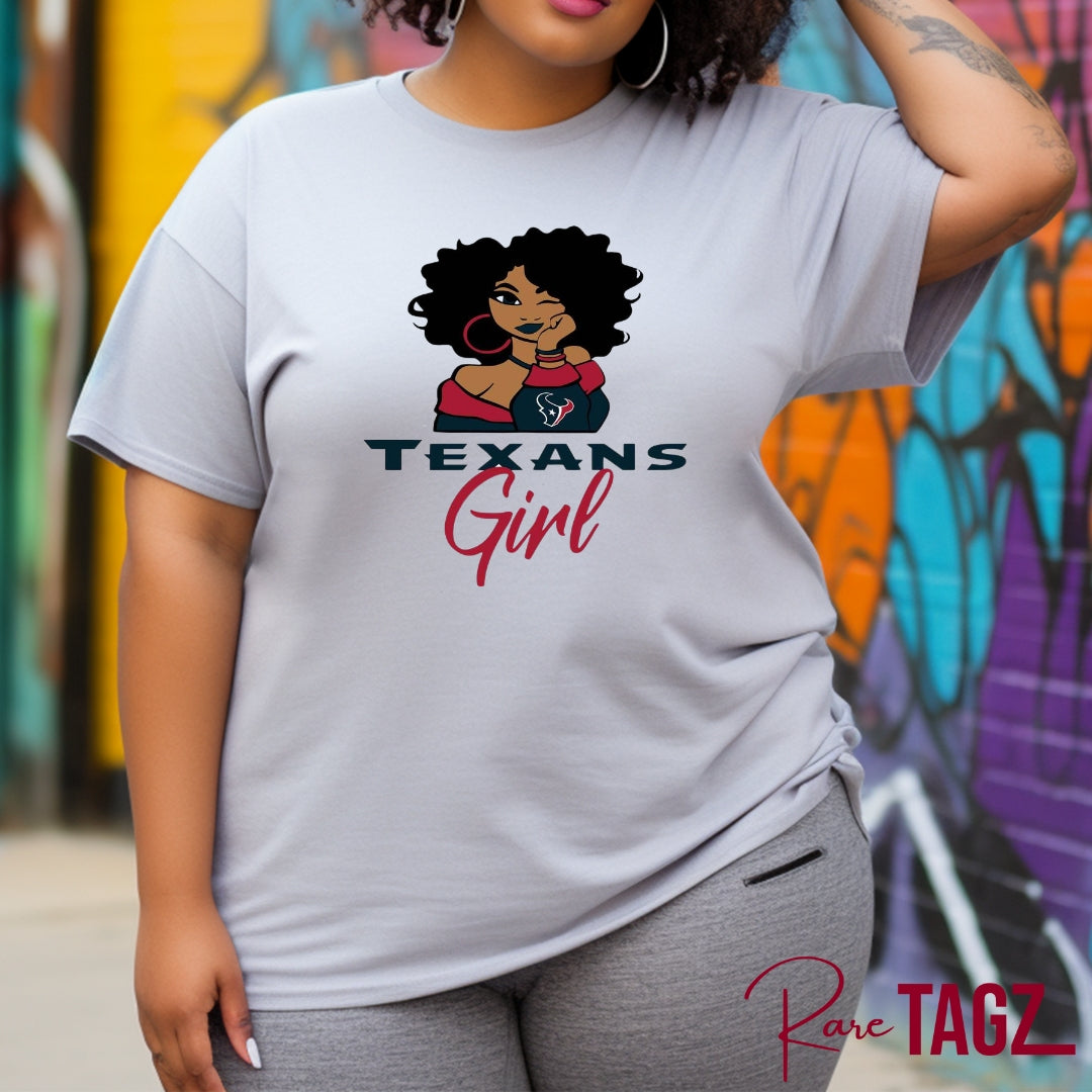 Stylish and comfortable t-shirt featuring a bold 'Texans Girl' graphic in vibrant colors. Made from a soft and durable cotton blend, this tee provides all-day comfort. It's perfect for proud Texas women who want to showcase their state pride in a fashionable way. The shirt pairs well with jeans, shorts, or skirts, making it ideal for casual outings and everyday wear. Available in various sizes to fit all body types, this Texans Girl T-Shirt is a must-have for any Texas enthusiast.