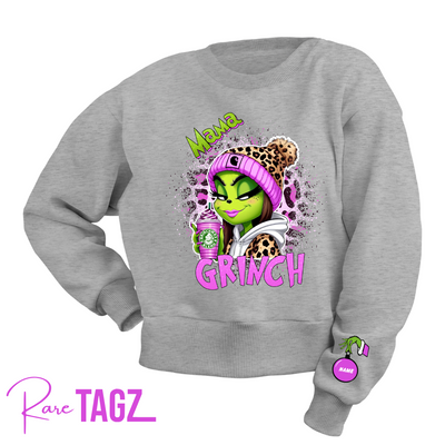 Customizable sweatshirt featuring a playful 'Mama Grinch' design. The sweatshirt can be personalized with the names of kids, making it a unique and festive piece. Perfect for moms looking to celebrate the holiday season with a touch of fun and personalization.